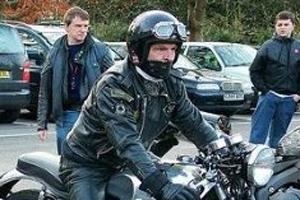 Motorcycle rider following helmet laws