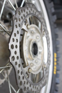 Closely inspect the brake rotors for signs of wear or and cracking. Some grooving is normal, and a service manual should list the rotor's wear limits.