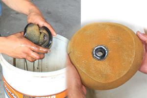 Fill the bucket with the cleaning fluid, and drop in the dirty filter, which sits just above bucket-bottom on a wire cage.