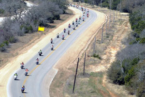 Riders navigate a long curve heading toward Belton Lake Outdoor Recreation Area