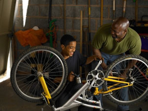 Kid and Dad fixing bike