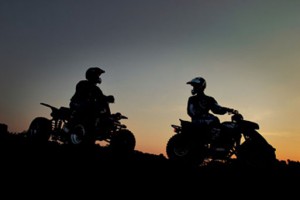 ATV riders at dusk