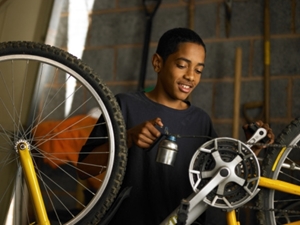 Youth fixing bicycle